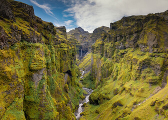 view of the Mulagljufur Canyon and the Mulafoss Waterfall at the end of the canyon in Southeast Iceland
