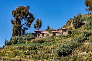 Naklejka premium The landscape and farmhouses on Taquile Island in Lake Titicaca, Peru 