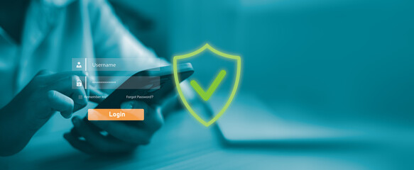 Hand holding smartphone with virtual login interface and security shield icon. Mobile cyber security, user authentication, data protection and safe digital access concept.