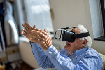 Elderly man using a virtual reality headset in a nursing home environment. Perfect for senior care, assisted living, technology, rehabilitation, and healthcare concepts.