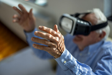 Senior man using a virtual reality headset in a nursing home.
