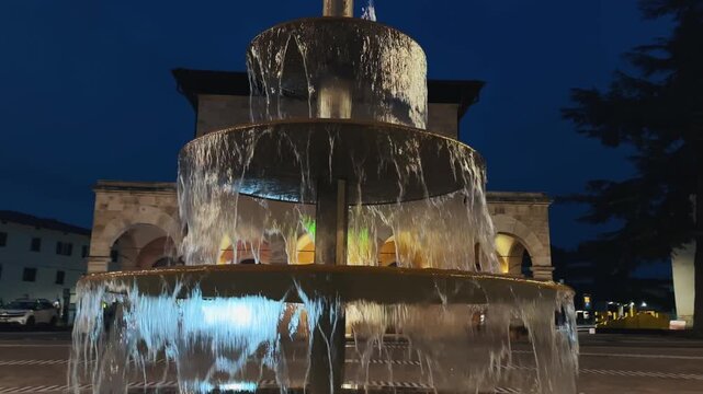 Illuminated Fountain in the twilight at city square at Colle di Val d'Elsa, Tuscany, Italy
