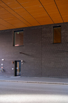 Modern brick facade minimalism with deep shadow and doorway in urban setting showing clean texture design for architectural background