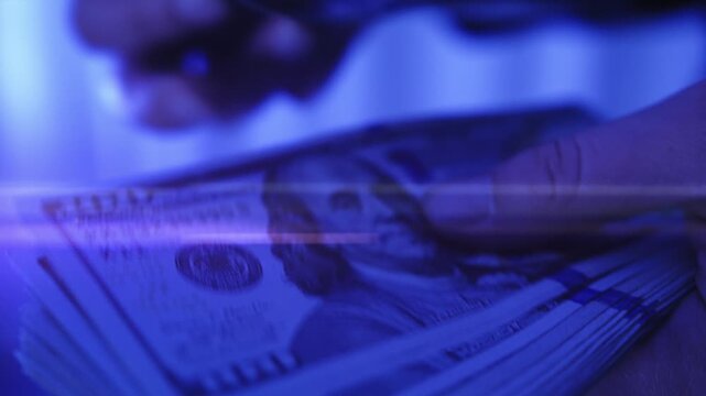 Counting euro and American 100 dollar banknotes on black background. Businesswoman counts the bills of money, rich woman shifting a stack of 50 US dollars by hands.