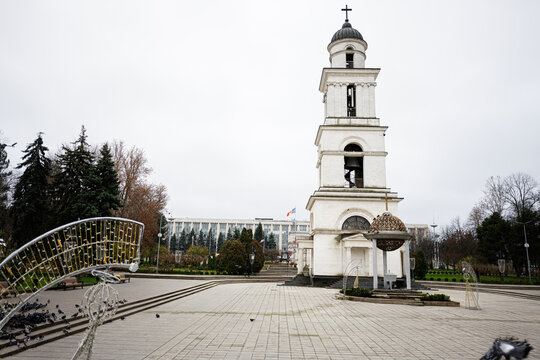 Historic church tower and open square in Chisinau Moldova with visitors and decorative sculptures. The Cathedral of Christ's Nativity.