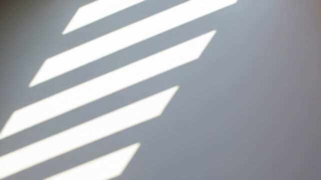Diagonal Stripes of Sunlight and Shadow on a Plain Gray Wall Keywords: sunlight, shadow, stripes, diagonal, light, gray, wall, abstract, pattern, contrast, geometric