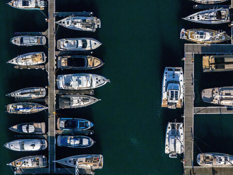 Aerial view of the marina, showcasing yachts and boats docked in neatly arranged rows, creating a striking geometric pattern on the water, Cascais, Lisboa, Portugal.
