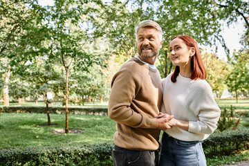 Fototapeta premium Couple enjoying a blissful walk together in a vibrant spring park filled with greenery