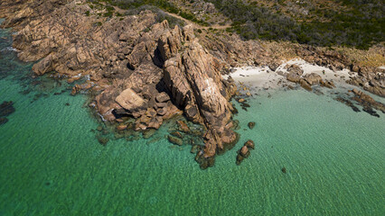 Aerial view of where the turquoise waters meet the rugged coastline, with dramatic rock formations contrasting against the sandy beach, Augusta, Western Australia, Australia.