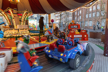 Colorful children carousel at festive winter city market © Kassandra