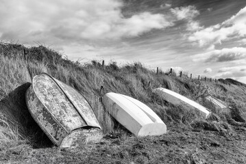 Boats upside down on the grass