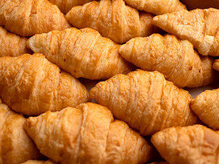 Top view of many fresh golden brown croissants pattern, Delicious French pastry for breakfast