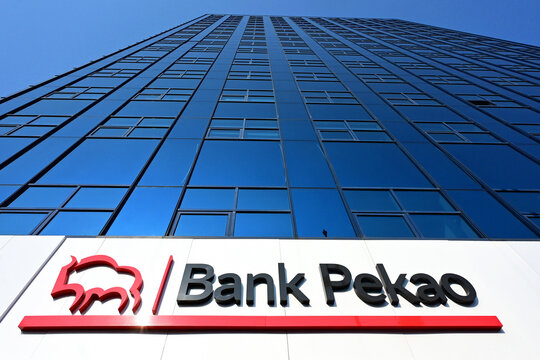 Lodz, Poland, Europe - 16.08.2025 : Logo and name of of Bank Pekao (Bank Polska Kasa Opieki) on glass facade of skyscraper in city center, the second largest bank in Poland, Sienkiewicza street
