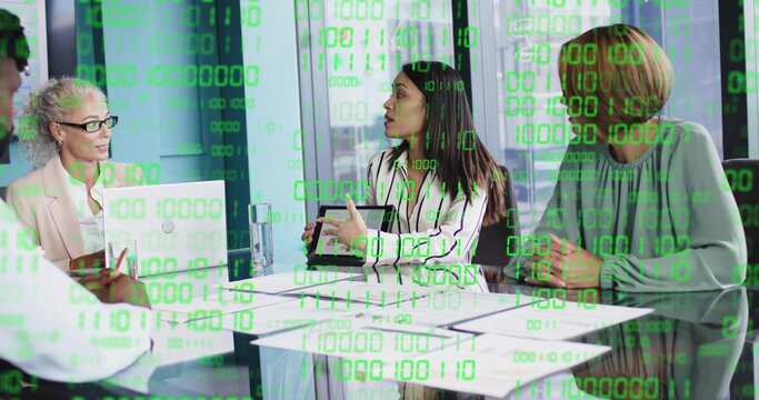 Presenting four in suits at glass table in meeting room with tablet laptop and binary overlay - Powered by Adobe