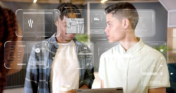 Discussing coworkers in plaid shirt and short-sleeve, reviewing AR tablet with coffee cup in office - Powered by Adobe