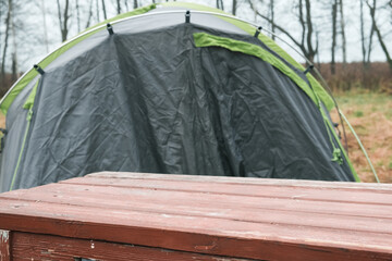 Table top on camping travel background. Display table For montage touristic, fishing, hunting product items ad. Design element visual layout. Copy space. Blank tabletop counter. outdoor travel stage.