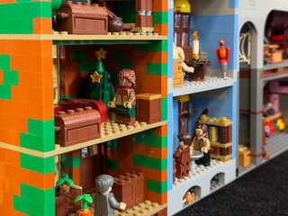 Obraz premium A detailed cross-section of a custom LEGO building featuring various furnished rooms, including a festive scene with a werewolf figure and a Christmas tree: 06/10/2024-Ljubljana, Slovenia