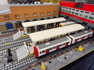 Obraz premium Miniature railway station diorama with passenger trains, platforms, and commuters built from lego plastic bricks.:06.10.2024-Ljubljana, Slovenia