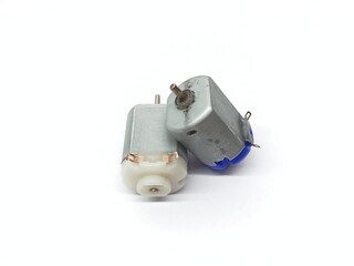 Small high-speed DC electric motor for miniature toy racing car isolated on white background
