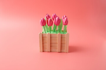 Small wooden planter box with pink pistachio shell tulips. Decorative handmade floral arrangement for interior design gift shop boutique event planning sustainable home styling cafe decoration