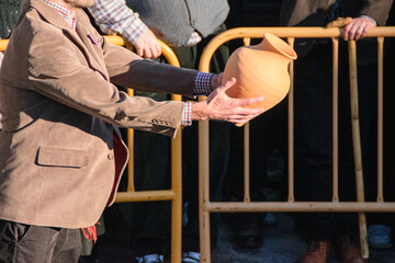 man holding a clay pots for the game of pot in xinzo de limia, domingo oleiro. Carnival time