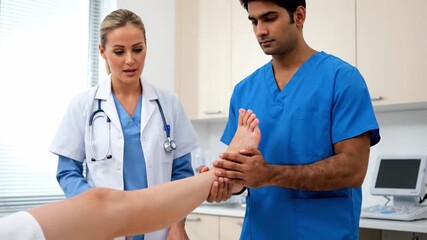 Physical therapy session focusing on leg rehabilitation with expert support in clinic