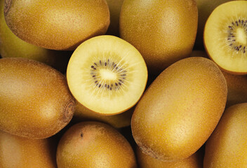 Fototapeta premium Kiwifruit Background Sliced Fresh And Juicy Yellow Kiwi Gold