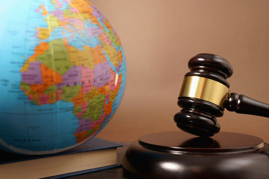 International Law Business And Global Justice Concept With A World Map Globe And A Judge Gavel