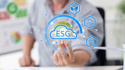 Businessman shows ESG virtual hologram with environmental social governance icons for sustainable business development corporate responsibility ethical investment ESG sustainable business