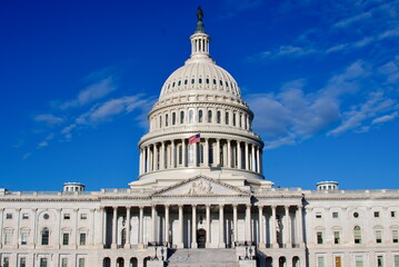 Capitol Building facade under blue sky with clouds Washington DC