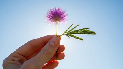 Young female athlete crossing the finish line with determination on a crowded track stadium