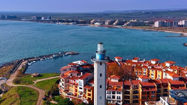 Footage at the top of the Aheloy lighthouse and bright Marina Cape hotel complex. Blue waterscape of the Black Sea at backdrop.