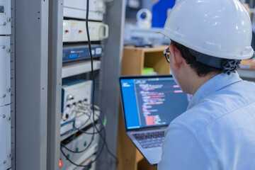 Electrical engineer male checking voltage at the Power Distribution Cabinet in the control room,preventive maintenance Yearly,inspecting power system and control panel in industrial factory