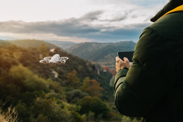 Man operating drone in scenic landscape