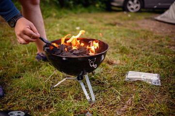 Close Camper Using Tongs Stoke