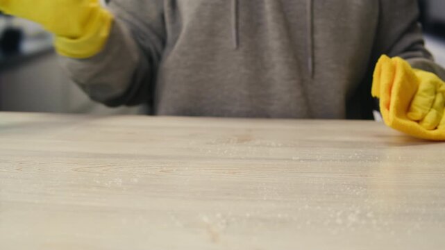 Cleaning service, Close up of woman cleaning table at home with spray. Homework, clean of ditry kitchen table with surface cleaner spray, all-purpose cleaner spray, multi-surface cleaning spray