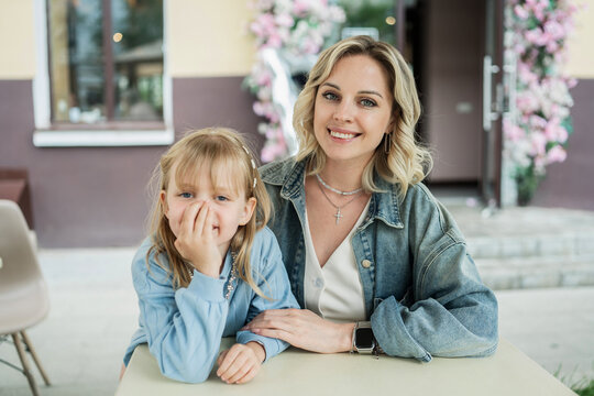 Mother and daughter enjoying cafe time outdoors