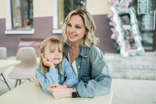 Mom and daughter enjoying cafe time outdoors