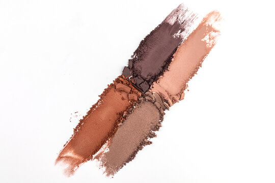 Assorted neutral makeup powder strokes on white