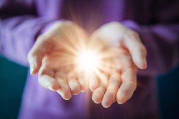 Woman Holding Glowing Light in Open Hands as Give to Gain Symbol of Empowerment and Sharing
