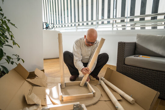 Senior engaged in diy woodworking project at home