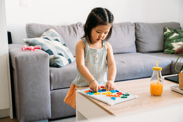 Young child playing with educational alphabet toys