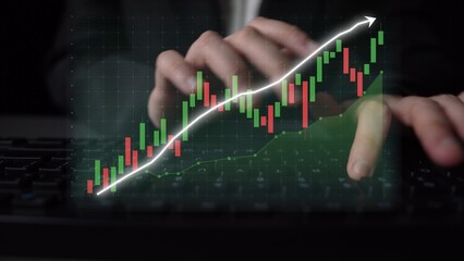 A business professional hands interact with a keyboard while analyzing financial data on a computer. The overlay of a stock market trend graph displays growth and performance. Copula