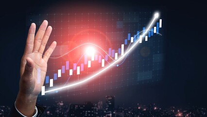 A close-up of a hand reaching toward a vibrant stock market graph, symbolizing financial growth and success, set against a dynamic urban skyline at night. Copula