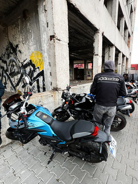 Group of friends and riders with Lifan KPT motorcycles in an urban graffiti filled parking area