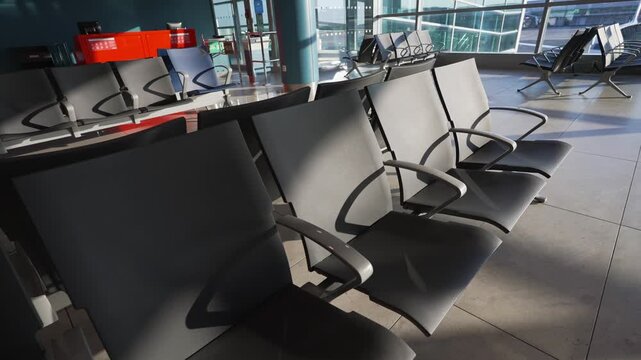 Empty seats in modern airport departure lounge.