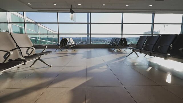 Empty seats in modern airport departure lounge.