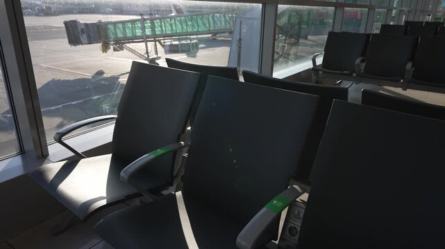 Empty seats in modern airport departure lounge.