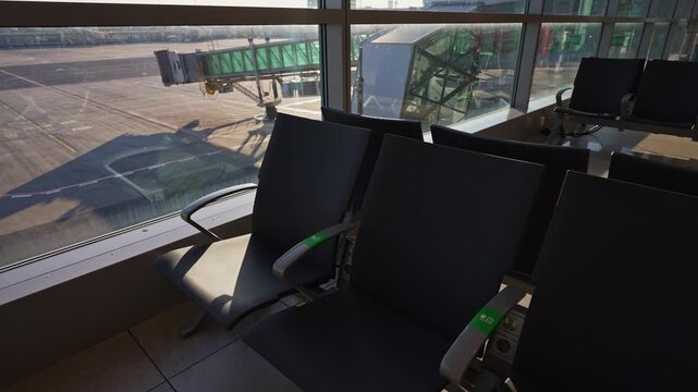 Empty seats in modern airport departure lounge.