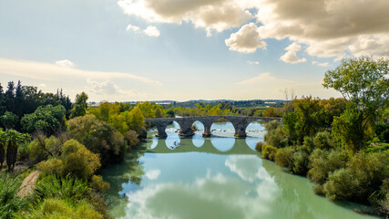 Fototapeta premium Belkis Koprusu areial dron photo. Seljuk bridge in Aspendos. The Eurymedon Bridge. Aspendos Yolu Belkis Mevkii. Turkey. Crooked Bridge over the Kopruchay (Euremedon) River near Aspendos, in Pamphylia,